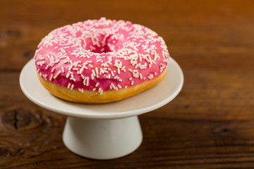 Colorful donuts on a wooden background.