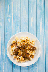 Potato noodles - dumplings on wooden background 