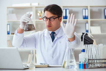 Young researcher scientist doing a water test contamination expe