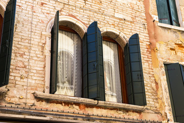 Fototapeta na wymiar retro style window shutters with white curtain