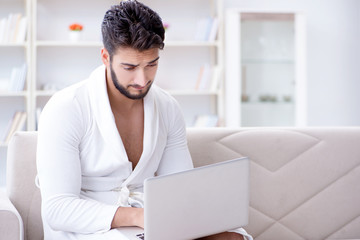 Young man freelancer working from home on a laptop