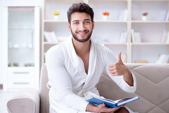 Young man student businessman reading a book studying working at