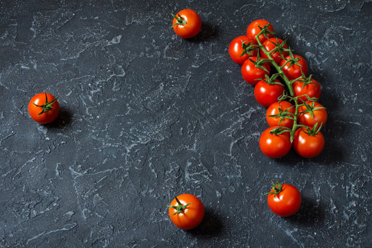 Fresh cherry tomatoes on stone background. Organic food