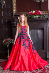Cute little redhead girl wearing an antique princess dress or costume. © artyme