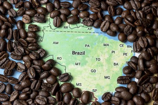 coffee concept - roasted coffee beans with a map background of Brazil.