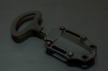 Black force knife in plastic case. Attack knife.