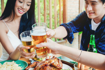 Group of young asian people celebrating beer festivals happy while enjoying home party