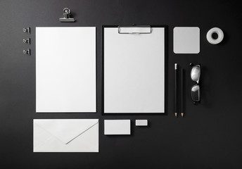 Photo of blank stationery set on black background. Corporate identity template. Responsive design mockup. Top view.