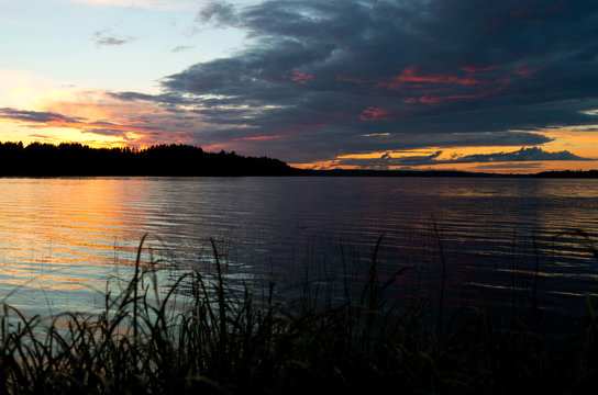 Heavy colorful sky above lake during the sunset time near Ikaalinen Finland