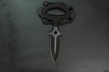 Knife push dagger. Black knife with double edge spear point blade.