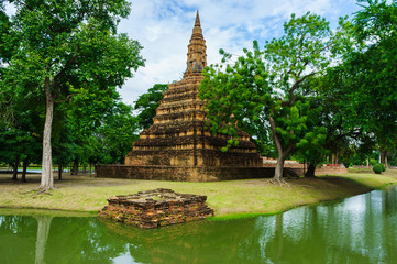 Fototapeta na wymiar Beautiful ancient brick pagoda stay in Ayutthaya, Thailand. This have forest and blue sky in background.