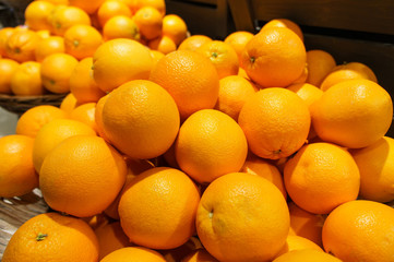 Stack of many fresh mandarin oranges in the market. For food, fruit, kitchen, texture, background and vegetables.