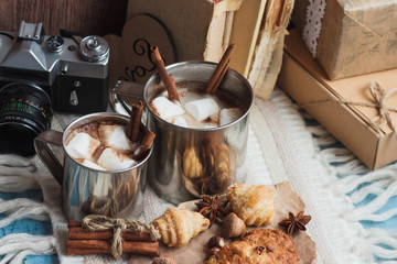 Metal mugs with cacao and marshmallows