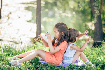 Children on grass smiling and playing in spinner