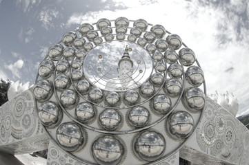 Big ball glass and white buddha statue