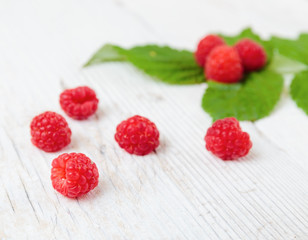 Raspberries on a wooden white table