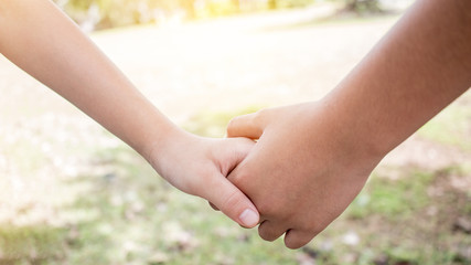 Asian little girls holding hands couple together show Relationship between sister and familay at gardren outdoor, Love parents friendship concept.