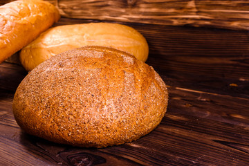 Different loafs of bread on wooden table
