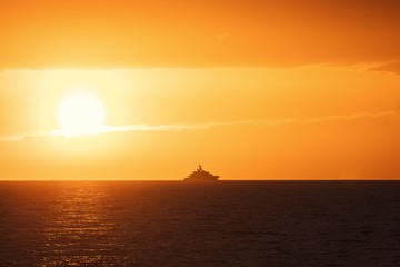 Fototapeta na wymiar Beautiful sunset at the sea with luxury yacht