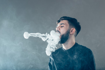 Vape trick rings in performance of vaper on red blue background