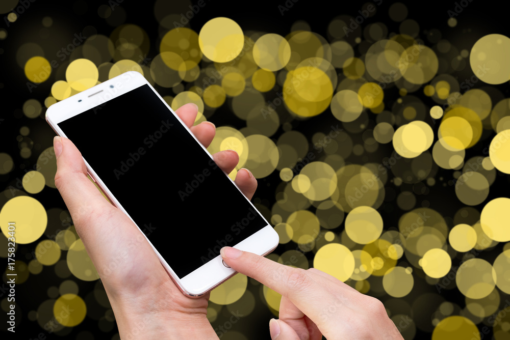 Poster woman hold smart phone and touch button by hand with blank screen for advertisement, yellow bokeh bl