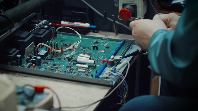 Close up of electronics engineer working with a circuit board