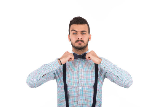 Handsome young man holding his papion, guy wearing light blue shirt,  isolated on white background