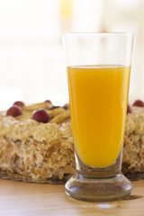 fresh orange fruit juice on glass cup with cake