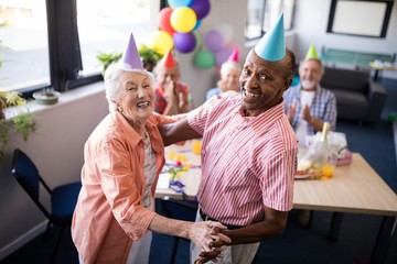 Obraz premium Portrait of happy senior couple dancing at party
