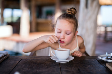 Little girl drinking hot chocolate