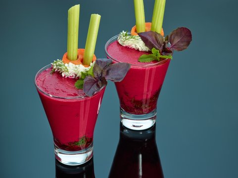 Italian gazpacho soup made of beets and tomatoes with celery in glasses