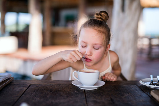 Little Girl Drinking Hot Chocolate