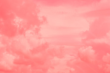 Pink sky background with white clouds.