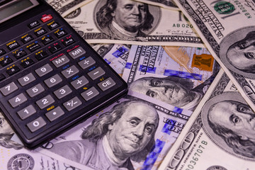 Modern calculator on a one hundred dollar bills