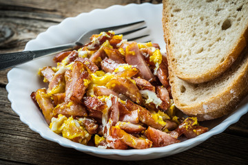 Pieces of sausage fried with egg.