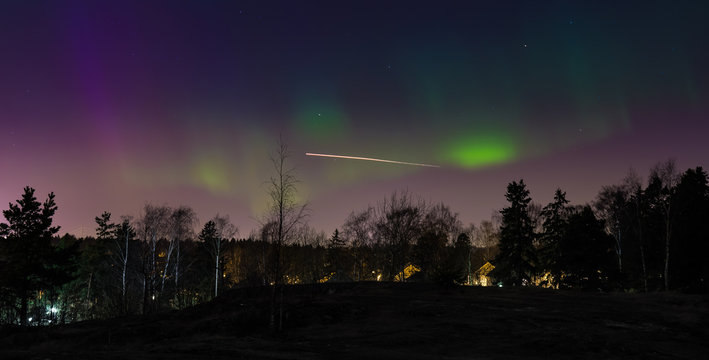 Aurora borealis above the Nordic forest captured in Helsinki Finlnad 