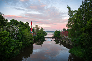 Sky and sunset are reflecting in mirror like water in Helsinki Finland 