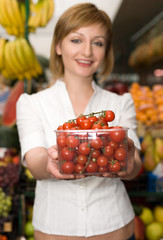 Woman with cherry tomatoes