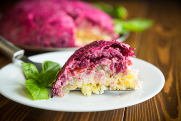 layered pastry salad with herring and beetroot