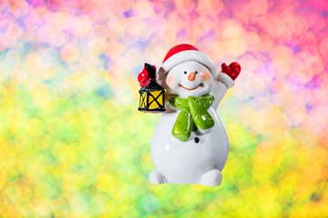 Christmas decor - snowman with lantern on multicolor background with copy space