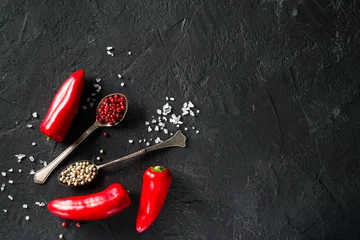 Foto op Plexiglas Some mini peppers, dry spices and salt over black background © Denira
