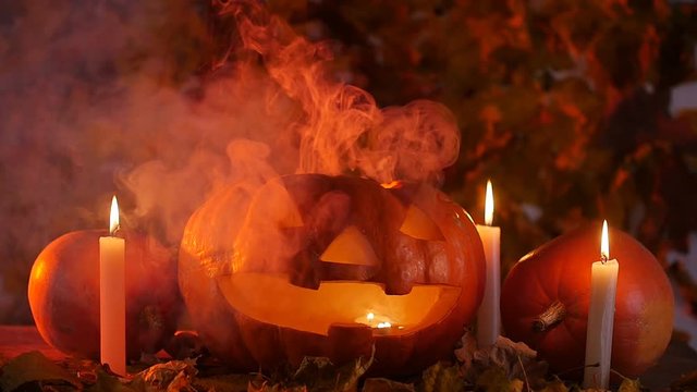 Glowing smoking monster pumpkin. Halloween concept