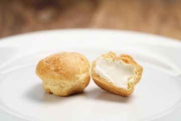 profiteroles on plate closeup one sliced