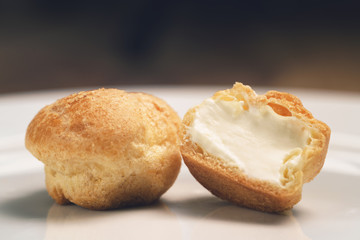 profiteroles on plate closeup one sliced