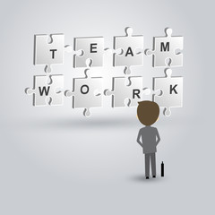 Teamwork concept of businessman looking to the jigsaw puzzle