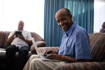 Portrait of senior man using laptop