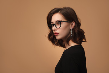 Attractive woman in glasses looking away