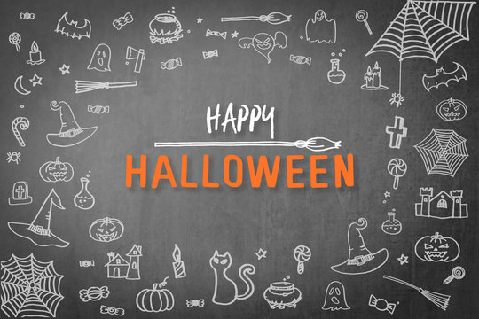 Halloween background for happy halloween holiday greeting festival celebration with chalk doodle on spooky dark black chalkboard with drawing of pumpkin, spider web, witch hat, trick or treat candies