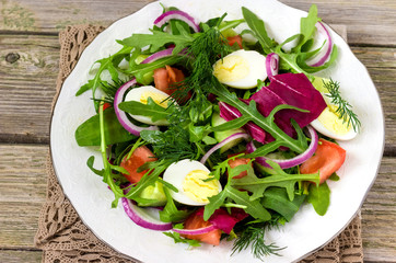Fresh salad of quail eggs and vegetables.