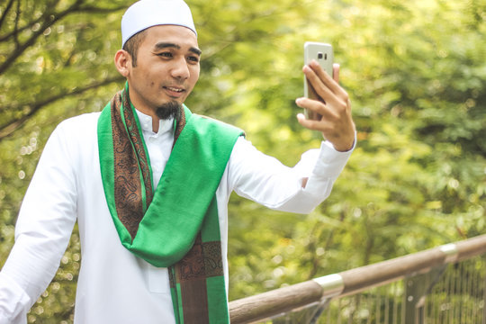 Muslim Man taking selfie picture in closeup shot